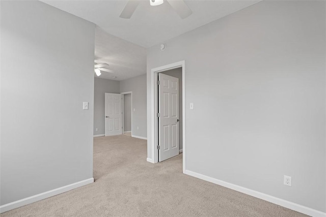 unfurnished room with ceiling fan and light colored carpet