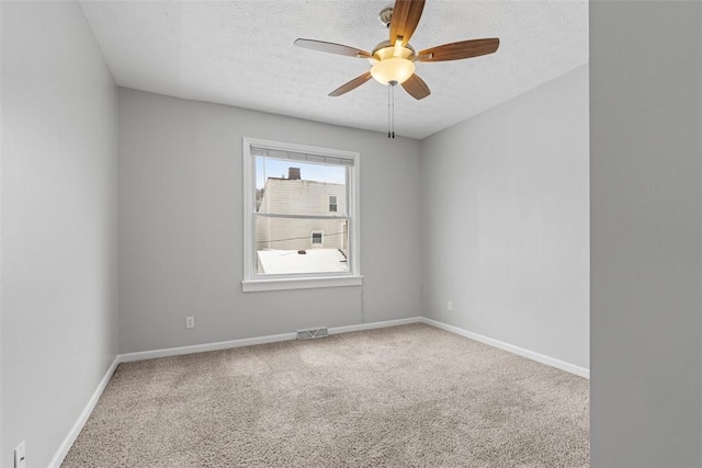 unfurnished room featuring carpet flooring, a textured ceiling, and ceiling fan