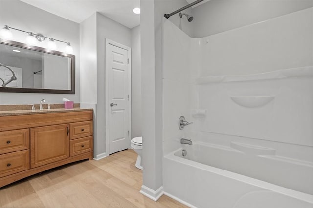 full bathroom with hardwood / wood-style floors, vanity, toilet, and shower / tub combination