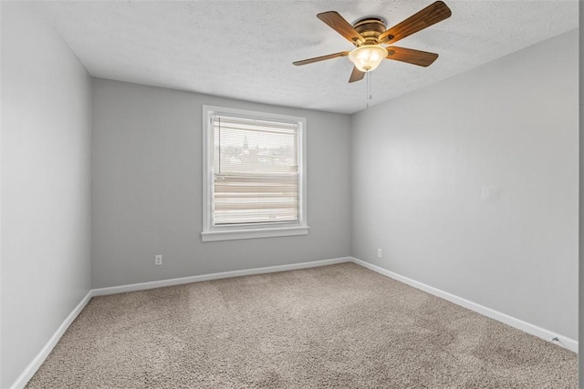 carpeted spare room with ceiling fan and a textured ceiling