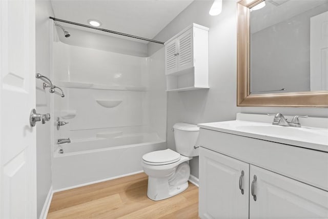 full bathroom with toilet, vanity, bathtub / shower combination, and hardwood / wood-style flooring