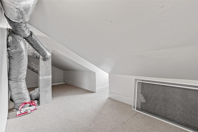 bonus room featuring lofted ceiling and light carpet