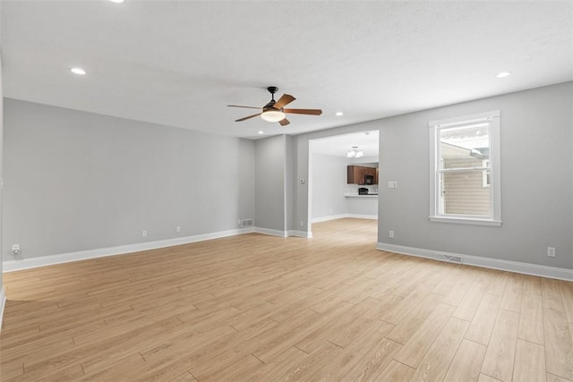 spare room with light hardwood / wood-style floors and ceiling fan