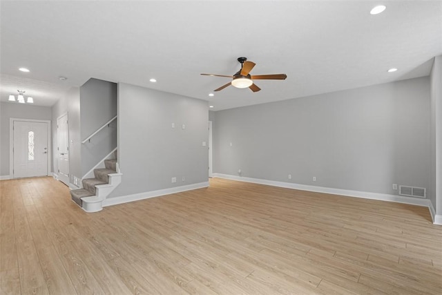 unfurnished living room featuring ceiling fan and light hardwood / wood-style flooring