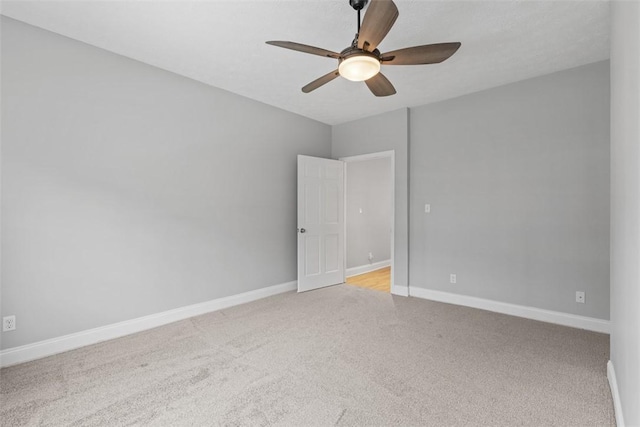 spare room featuring light carpet and ceiling fan