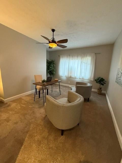 sitting room featuring carpet flooring and ceiling fan