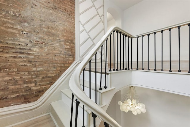 staircase featuring a chandelier