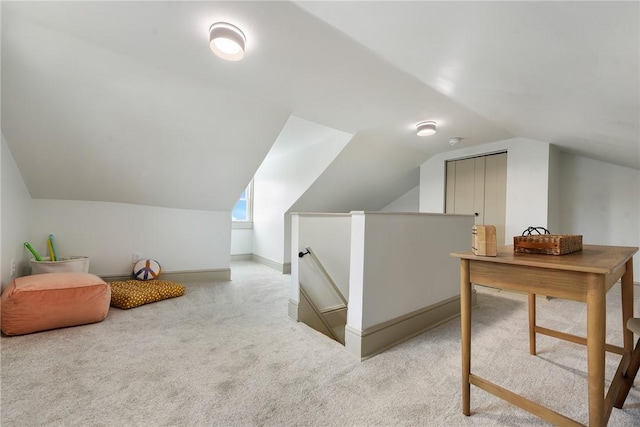 additional living space featuring light carpet and lofted ceiling