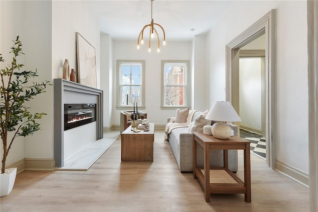 living area with light hardwood / wood-style floors and a chandelier