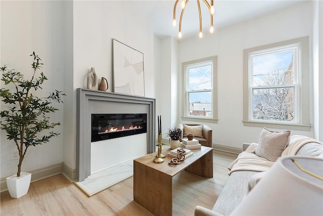 sitting room with an inviting chandelier and light wood-type flooring