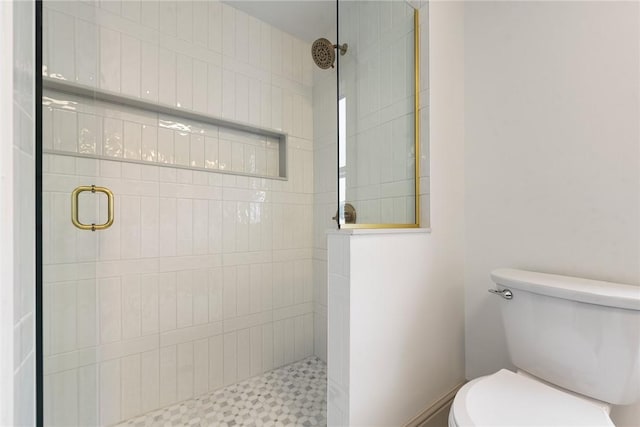 bathroom with an enclosed shower and toilet