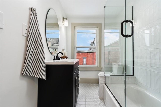 bathroom featuring shower / bath combination with glass door and vanity