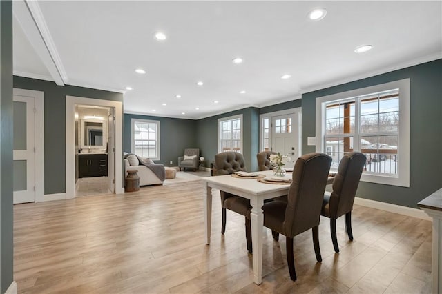 dining room featuring light hardwood / wood-style floors and ornamental molding