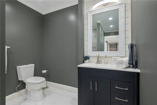 bathroom featuring vanity, toilet, and ornamental molding