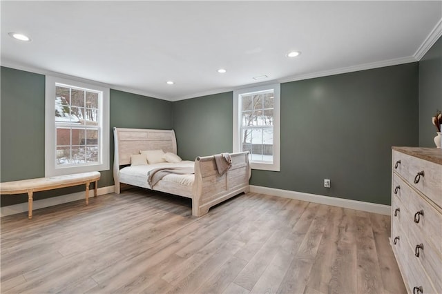 bedroom featuring light hardwood / wood-style flooring and crown molding