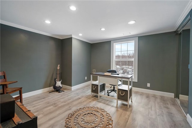 home office with light hardwood / wood-style flooring and ornamental molding