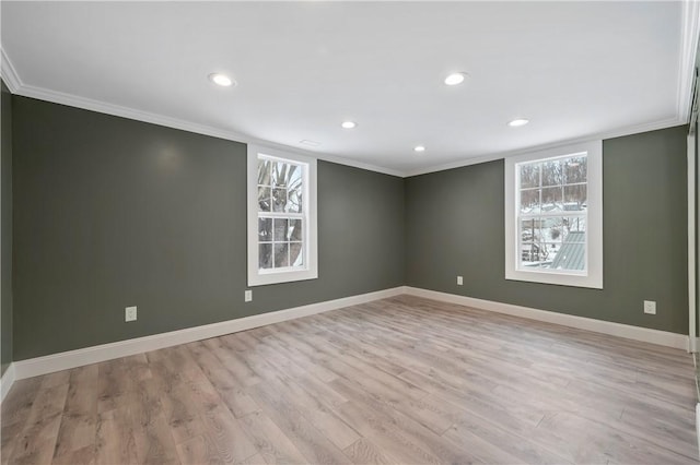 empty room with light wood-type flooring and ornamental molding