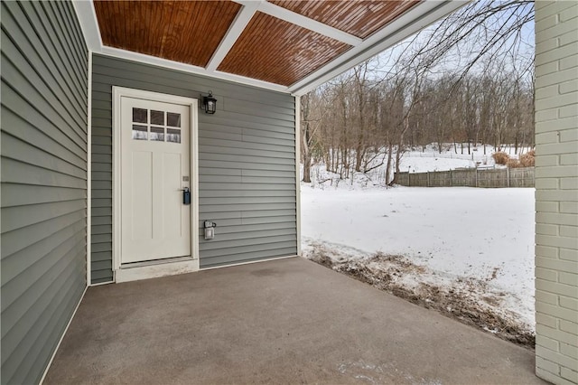 view of snow covered property entrance