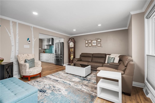 living room with crown molding and light hardwood / wood-style flooring