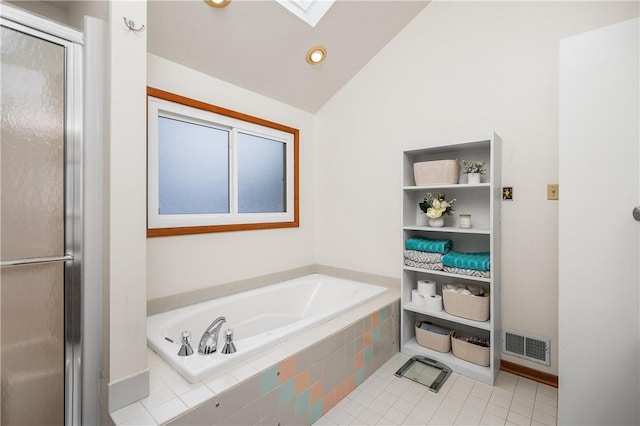 bathroom featuring tile patterned flooring, independent shower and bath, and vaulted ceiling