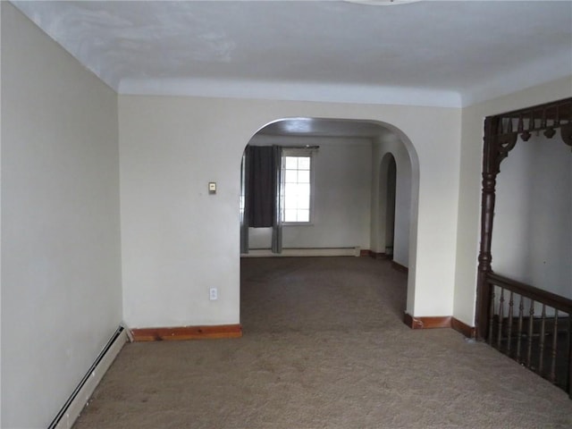 carpeted spare room featuring a baseboard radiator