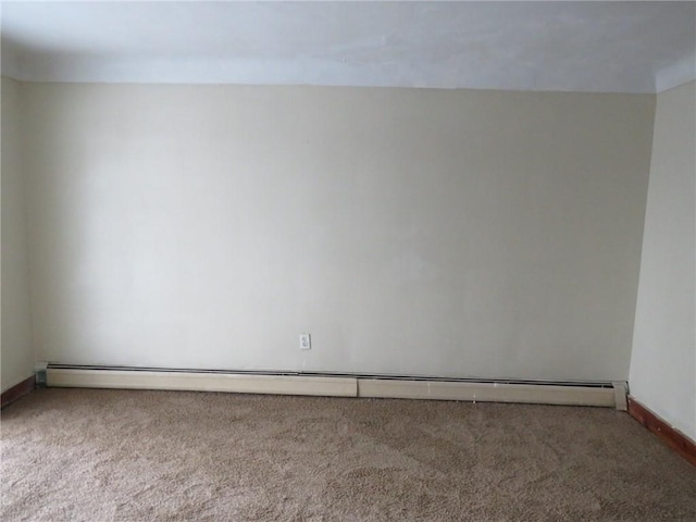 empty room featuring baseboard heating and carpet floors