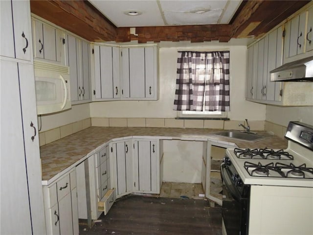 kitchen with white cabinets, dark hardwood / wood-style flooring, white appliances, and sink