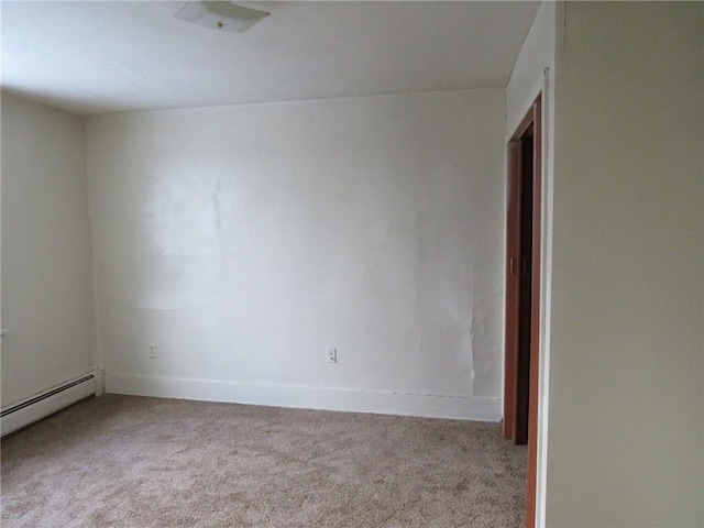 carpeted empty room with baseboard heating