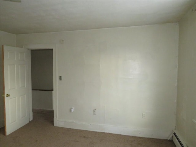 carpeted spare room featuring baseboard heating