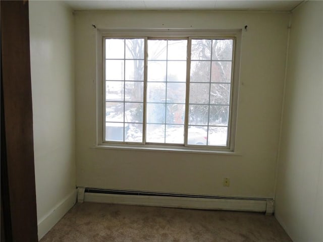 carpeted empty room featuring a baseboard radiator