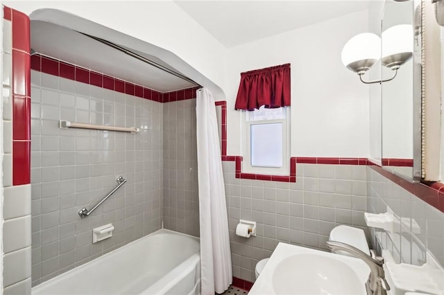 bathroom featuring shower / bath combo, toilet, and tile walls