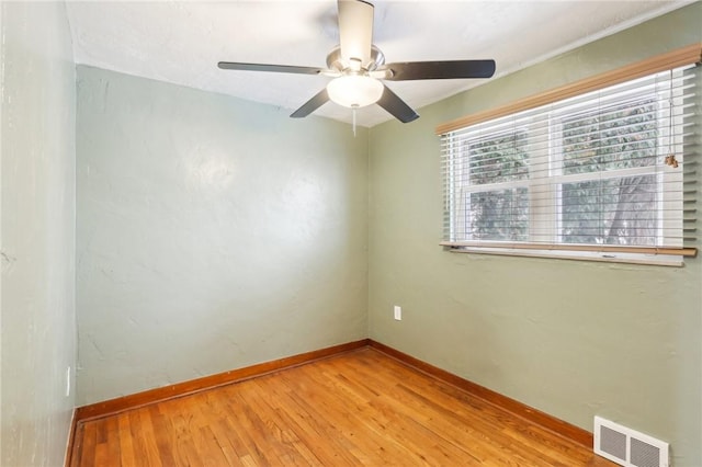 empty room featuring ceiling fan and light wood-type flooring