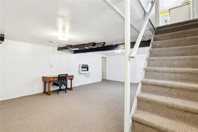 basement with carpet flooring and heating unit