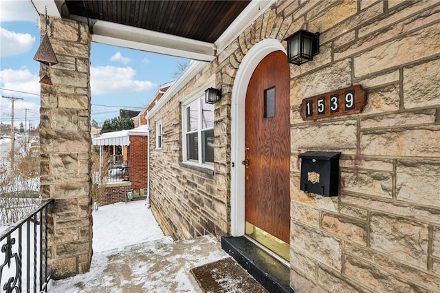 view of snow covered property entrance