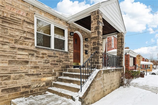 view of snow covered property entrance