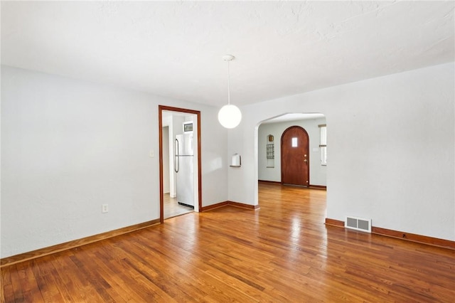 empty room with hardwood / wood-style floors