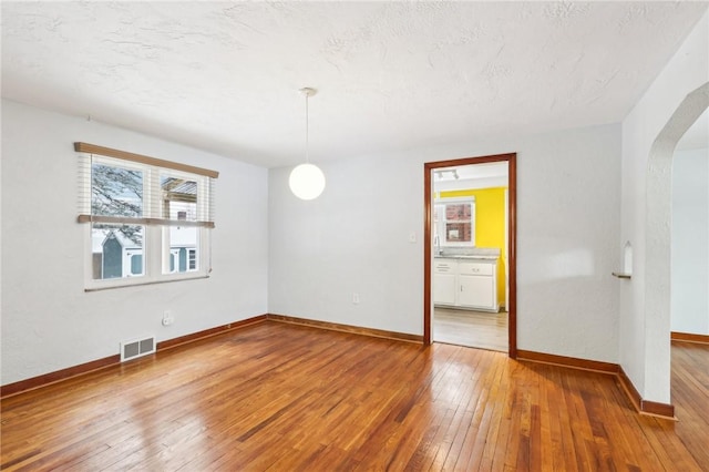 spare room with wood-type flooring