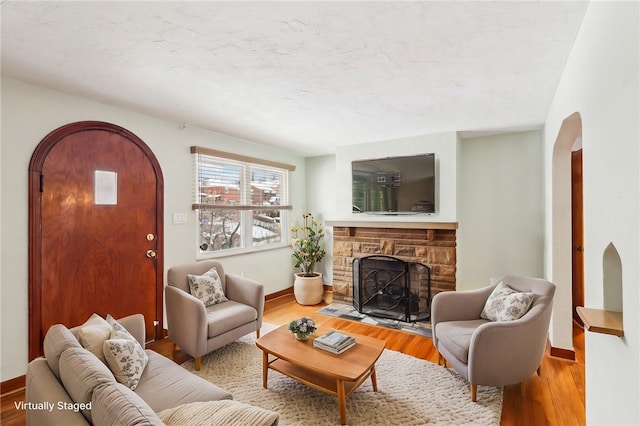 living room featuring hardwood / wood-style flooring and a fireplace