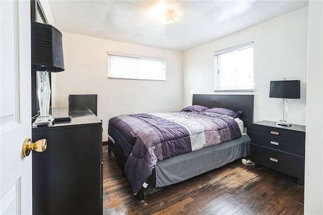 bedroom with dark hardwood / wood-style flooring