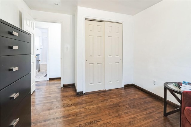 bedroom featuring dark hardwood / wood-style floors and a closet