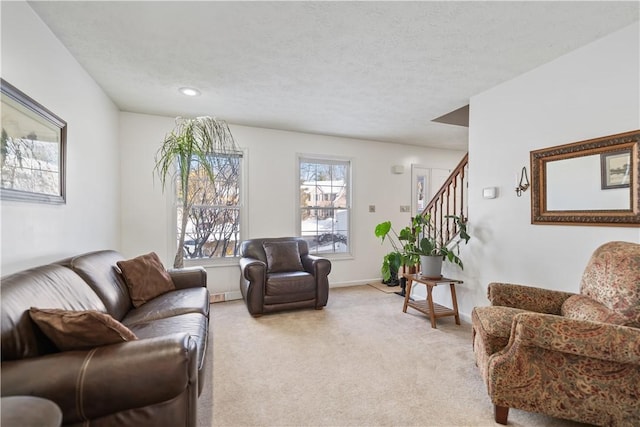 carpeted living room with a textured ceiling