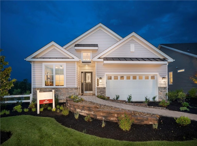 craftsman house featuring a front yard and a garage