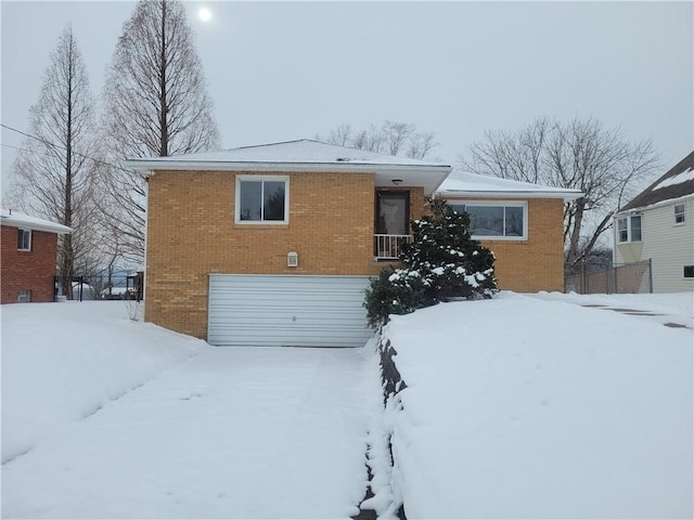 snow covered house with a garage