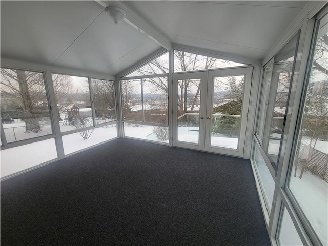 unfurnished sunroom featuring lofted ceiling with beams