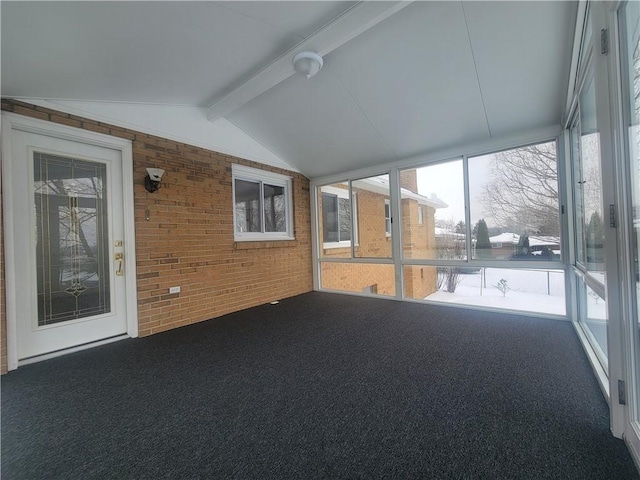 unfurnished sunroom with lofted ceiling with beams