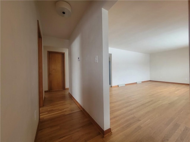 corridor with light wood-type flooring