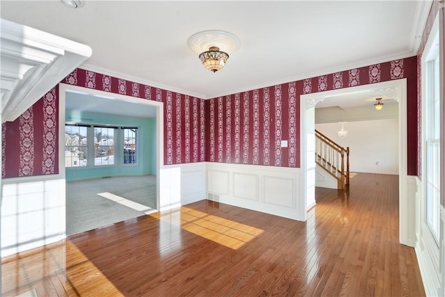 unfurnished room with hardwood / wood-style floors and a notable chandelier