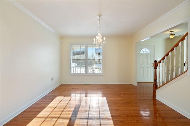 interior space with crown molding, a chandelier, and wood-type flooring