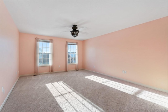 carpeted spare room with ceiling fan