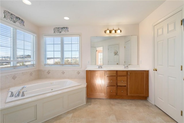 bathroom with vanity, a tub to relax in, and tile patterned floors